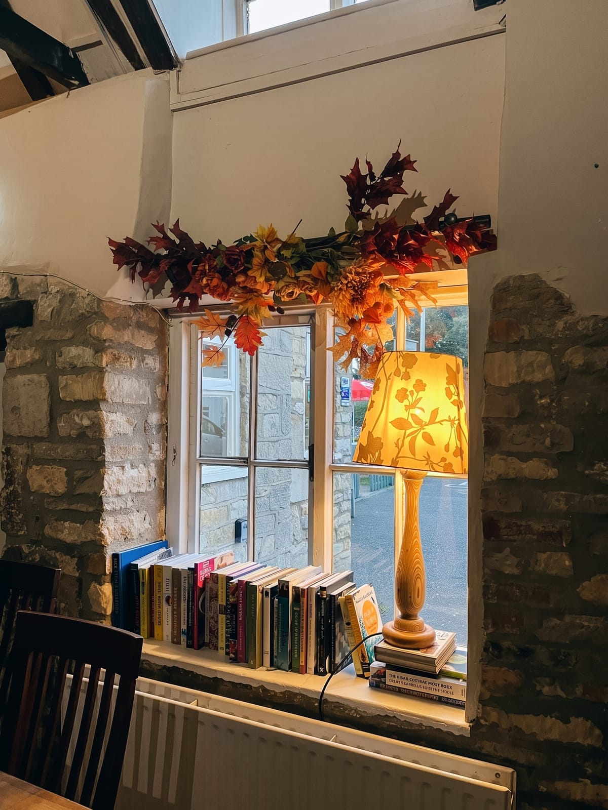 A window seat with books and a lamp