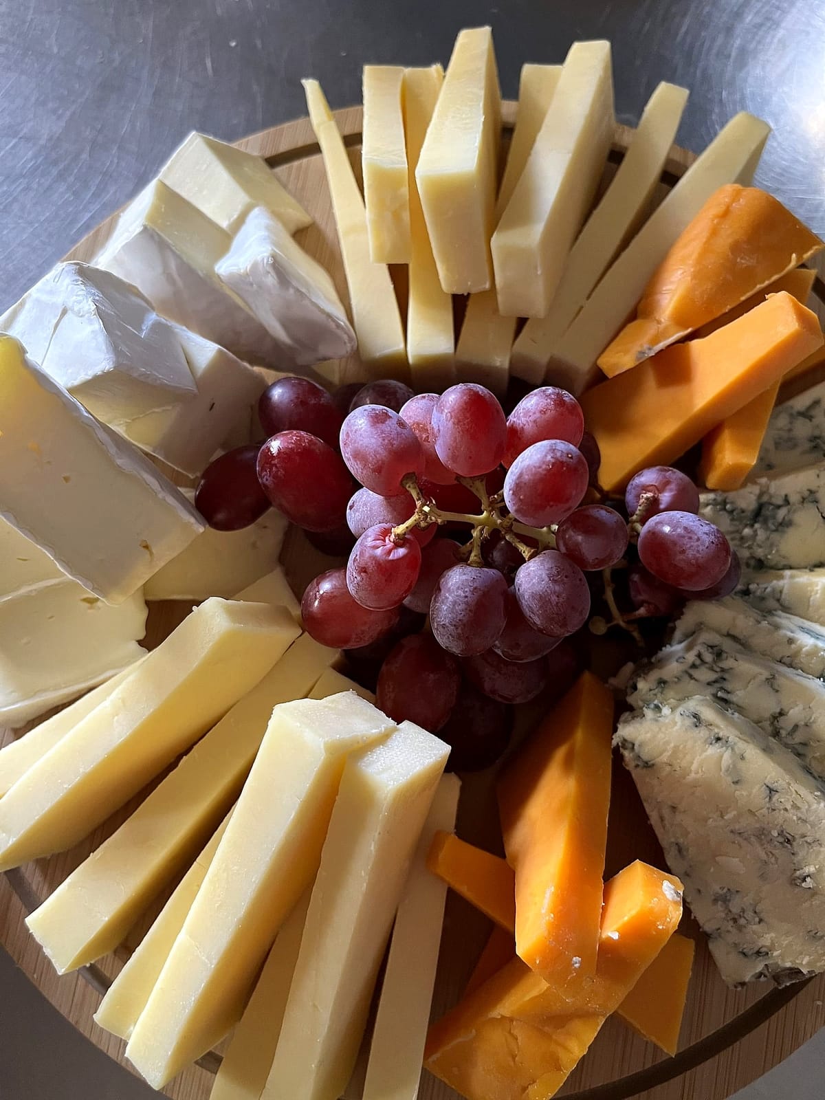 A cheeseboard with grapes