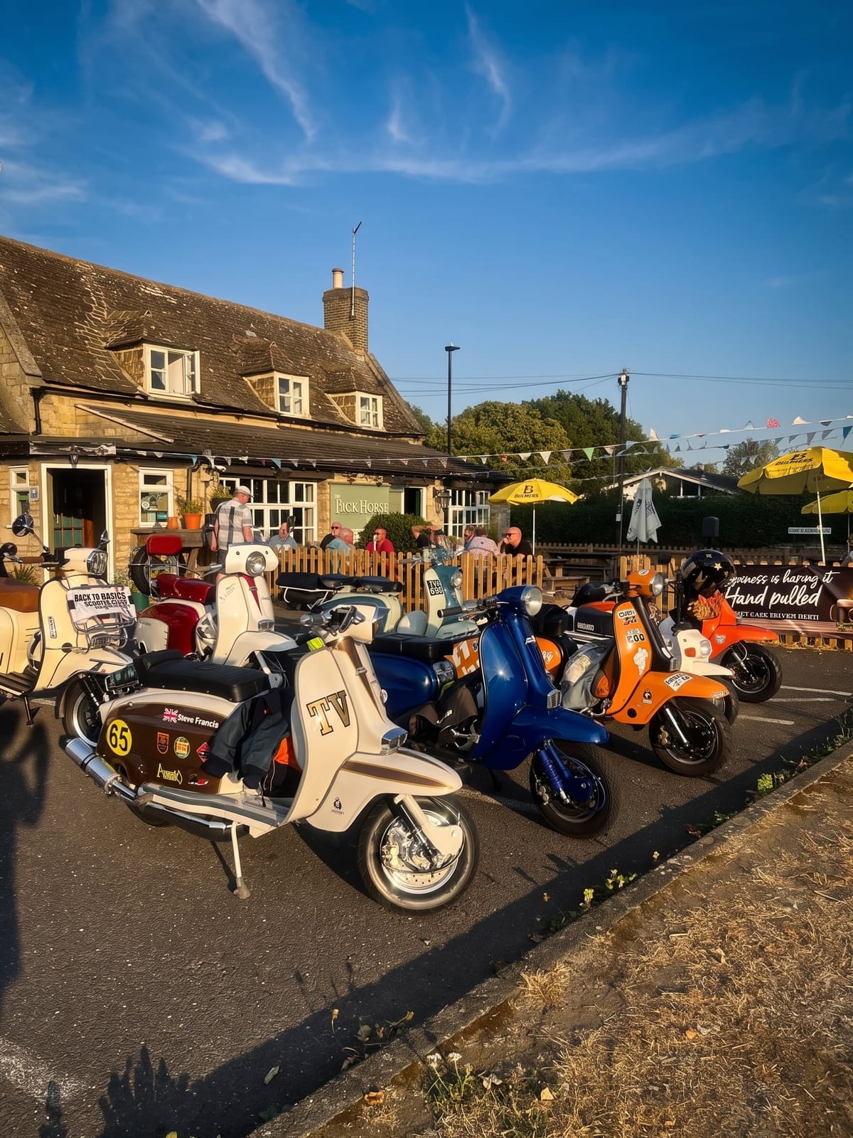 Vintage scooters outside the pub on a summer evening